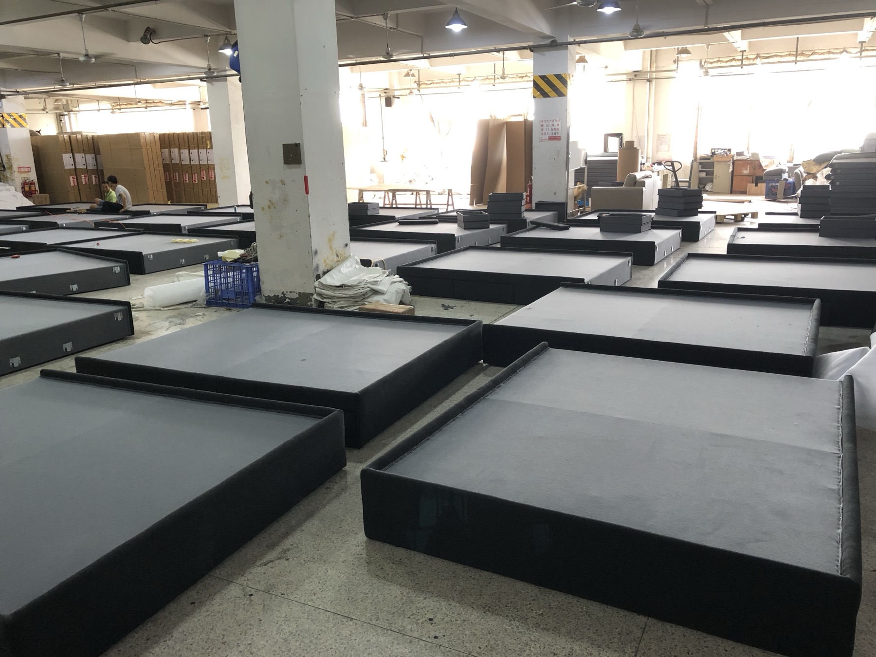 Upholstered bed frames in production at Baotian Furniture