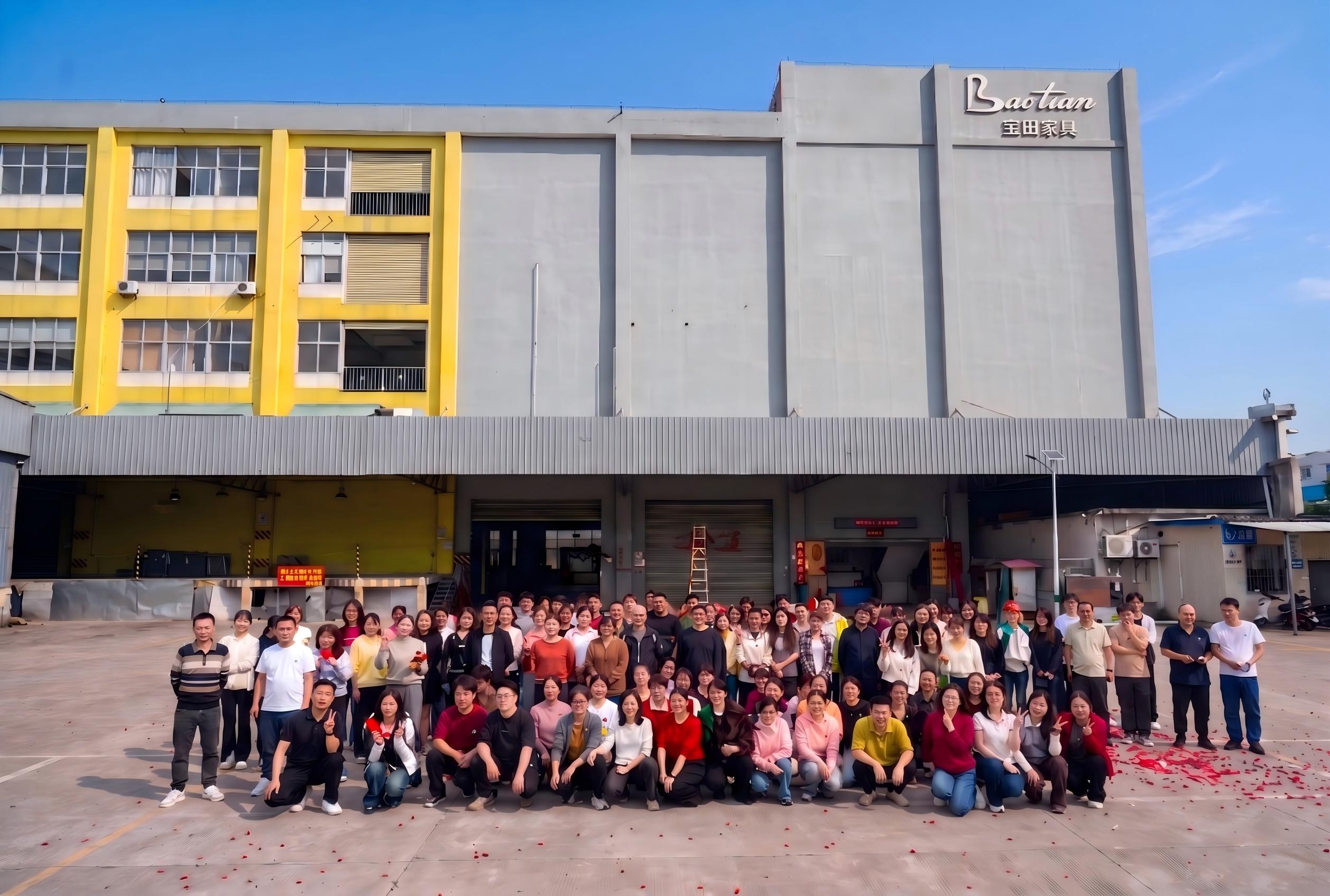 Baotian Furniture team in front of the company factory in Foshan, China