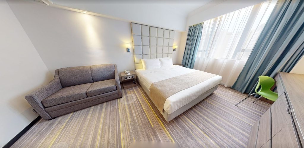 Hong Kong hotel guest room with sofa bed seating