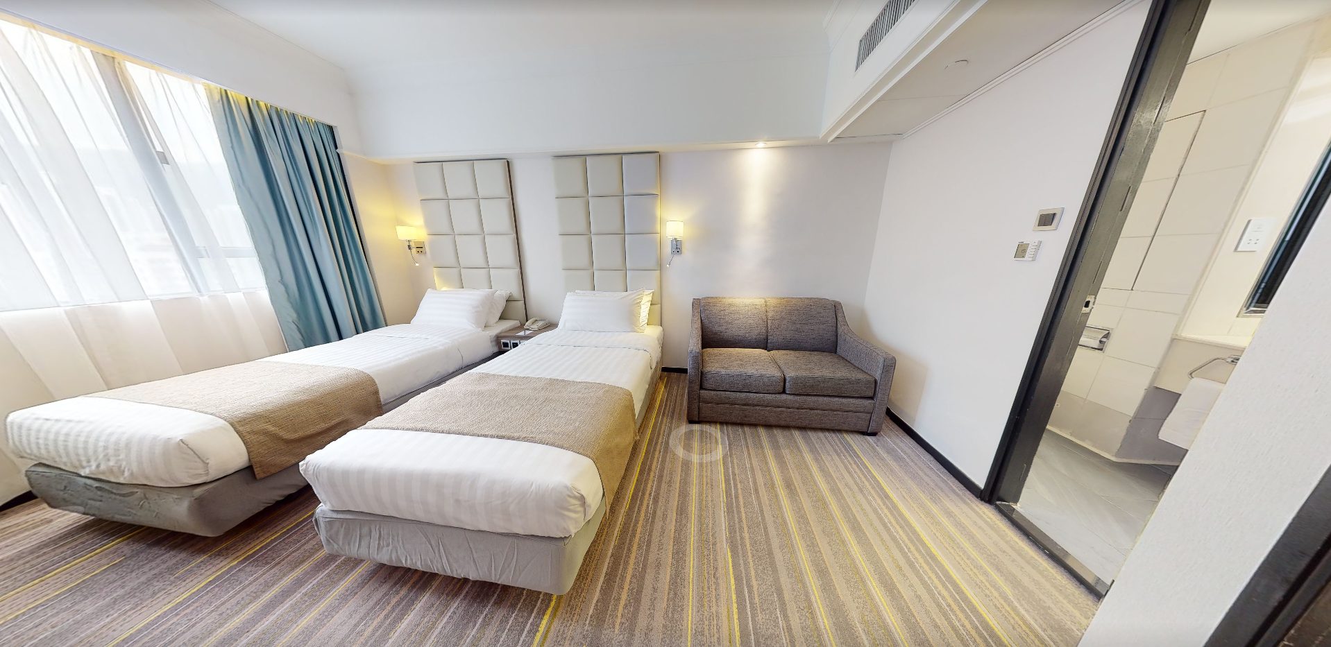 Hong Kong hotel twin guest room with custom sofa
