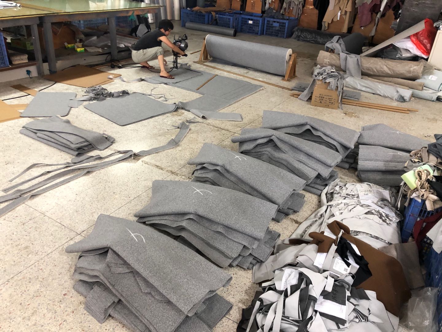 Cut grey upholstery panels prepared for a Canadian hotel furniture project