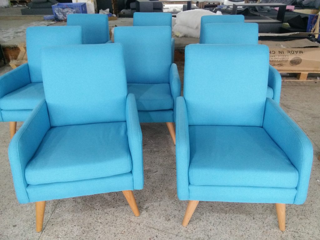 Blue upholstered hotel armchairs prepared for export
