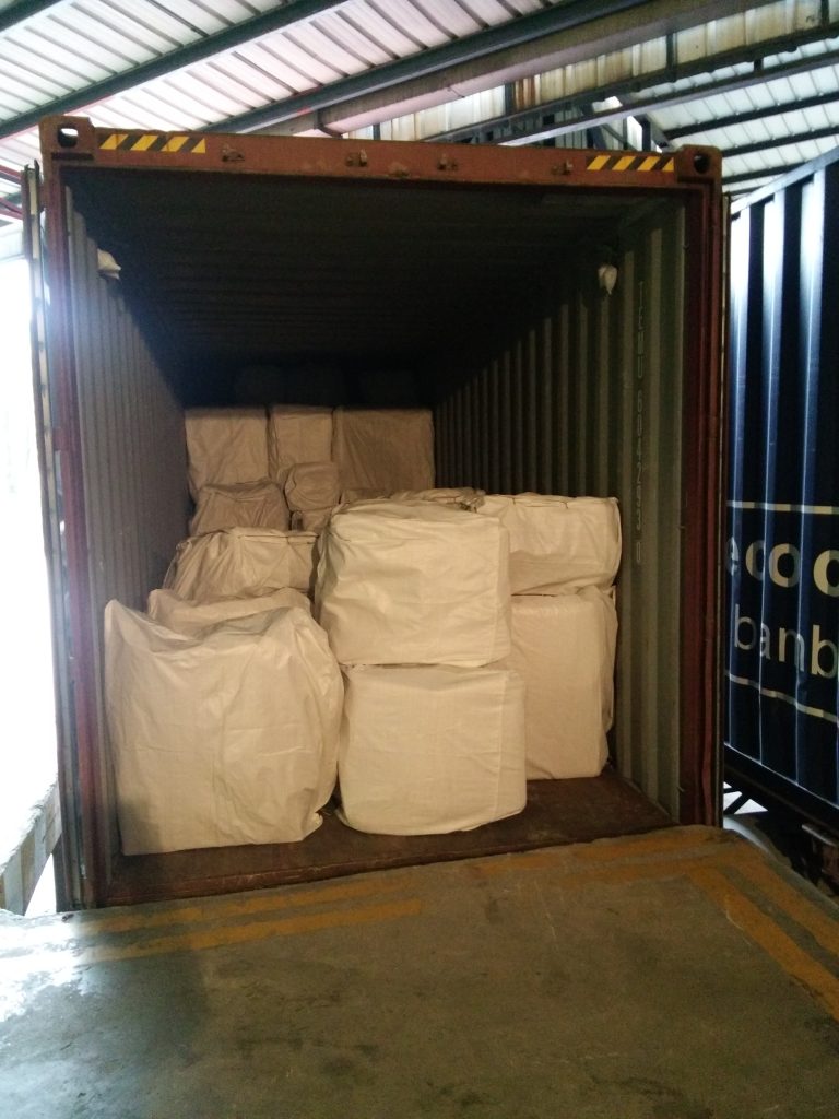Packaged hotel furniture inside a shipping container