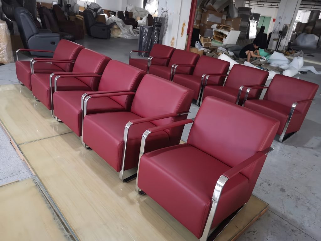 Red upholstered hotel chairs during factory production