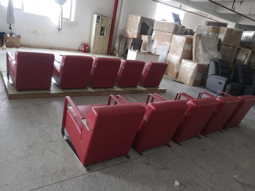 Red upholstered hotel chairs prepared for inspection and packing