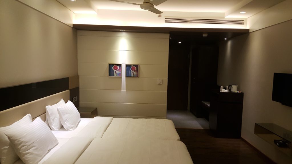 Shakti Hotel guestroom furniture and bed from the entry side