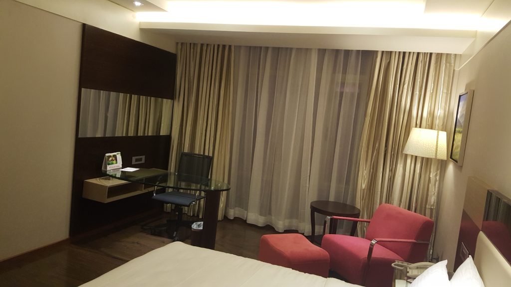 Shakti Hotel guestroom seating and bed presentation
