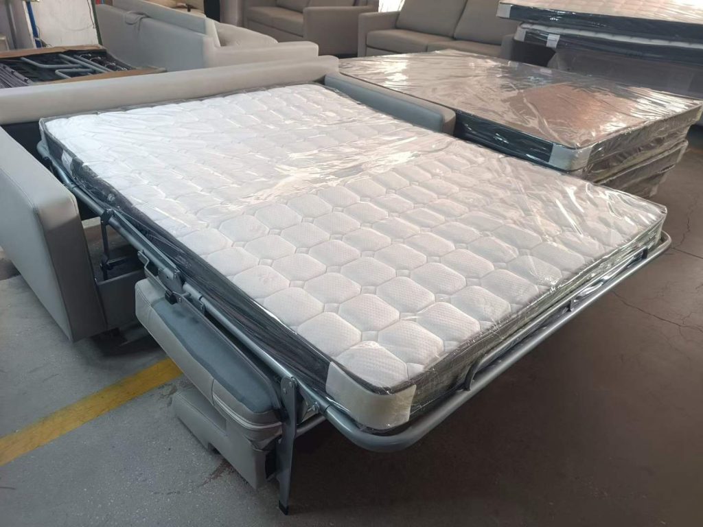 Sofa bed opened to show the extended deck and a wrapped mattress