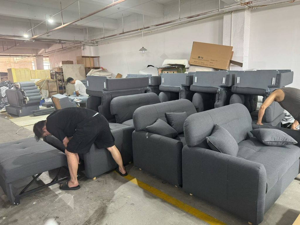 A worker checking the pull-out section of a sofa bed in the workshop