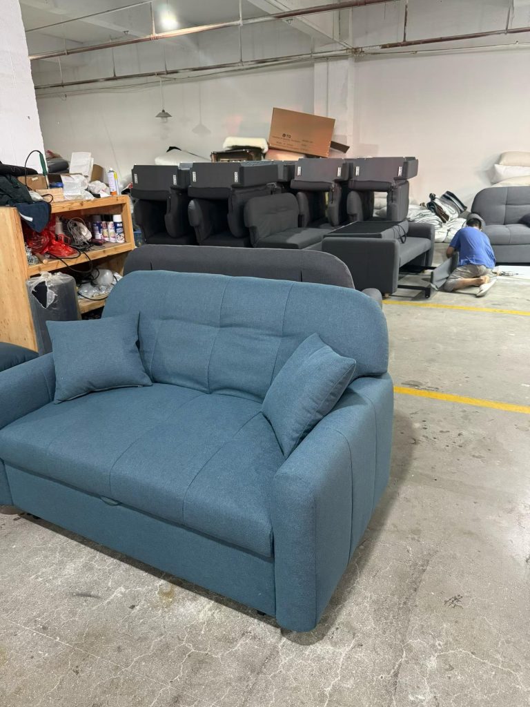 Blue-grey sofa bed showing its upholstered seat, back and arm stitching
